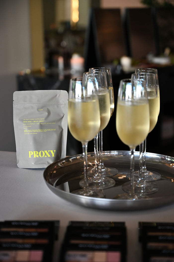 Proxy pouch beside champagne flutes