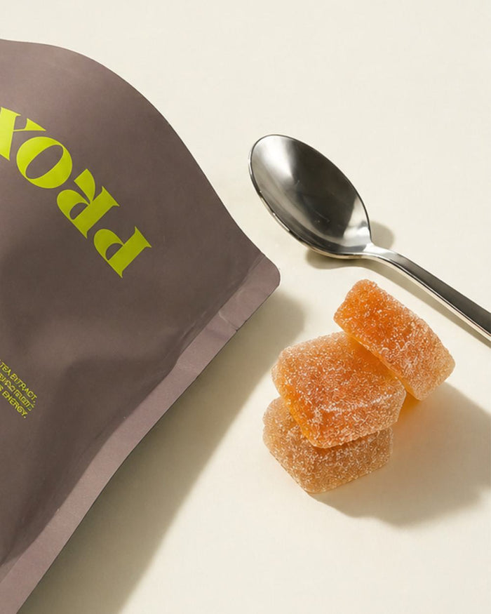 Panic Sour gummies next to the pouch and a spoon